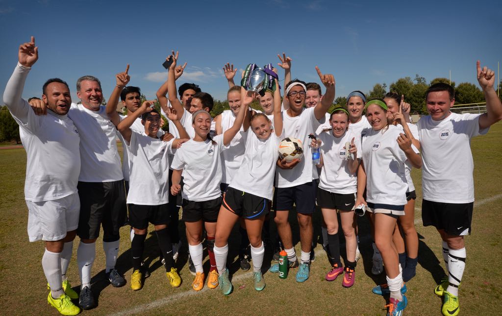The Beckman soccer team holds the Kelsey Harris Memorial Cup after defeating the the Tustin and Irvine police departments in a soccer game at Beckman High to raise money and awareness for Lafora research. Photo by Steven Georges/Behind the Badge OC