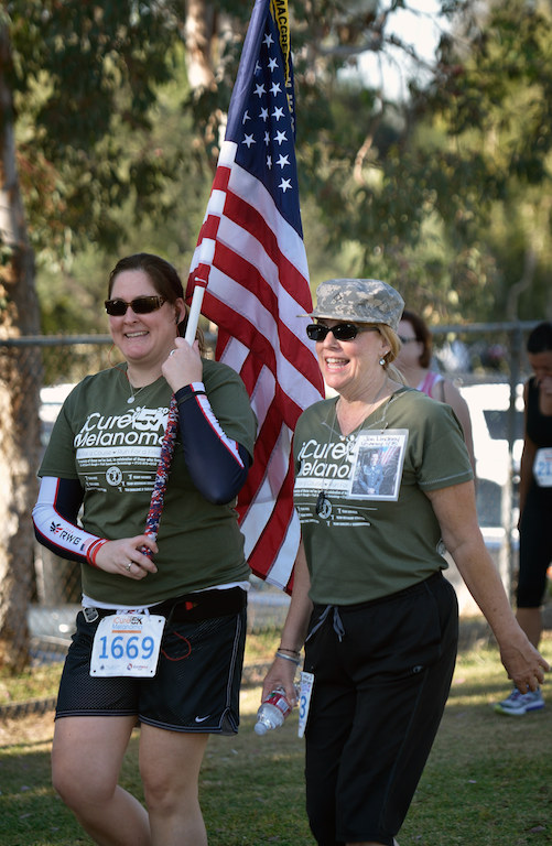 Sydney Salcido, left, walks with Karen MacDonald during the iCureMelanoma 5k at Laguna Rd. School Park in Fullerton to raise money funding research for a cure for Melanoma Cancer. Photo by Steven Georges/Behind the Badge OC