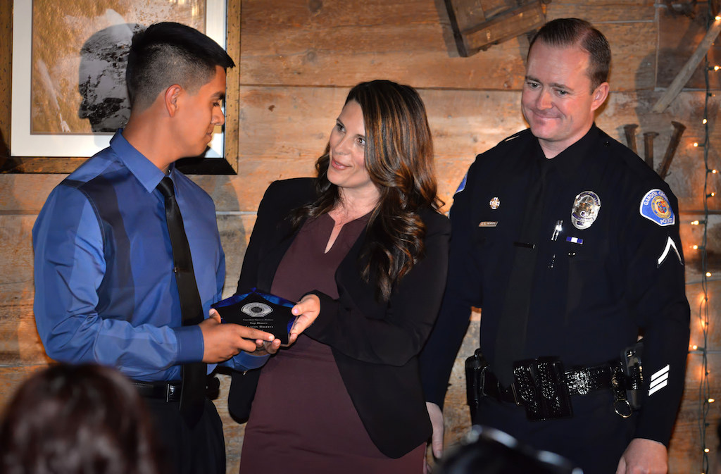 Explorer Jason Brito, left, receives the Top Hours Award from Janelle Weinberg and Officer Jason Perkins during the Garden Grove Police Explorer Post 1020 Awards Banquet. Photo by Steven Georges/Behind the Badge OC