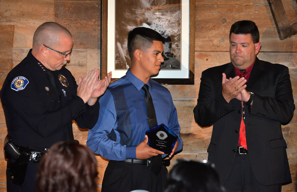 Explorer Jason Brito receives the Top Hours Award from Police Chief Todd Elgin, left, and Sgt. Bill Allison during the Garden Grove Police Explorer Post 1020 Awards Banquet. Photo by Steven Georges/Behind the Badge OC