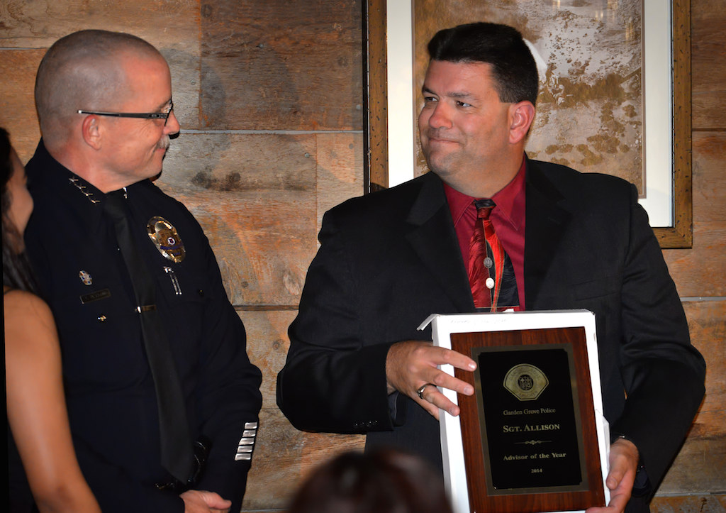 Senior Explorer Advisor Sgt. Bill Allison, right, smiles as he receives the Advisor of the Year Award during the Garden Grove Police Explorer Post 1020 Awards Banquet. Photo by Steven Georges/Behind the Badge OC