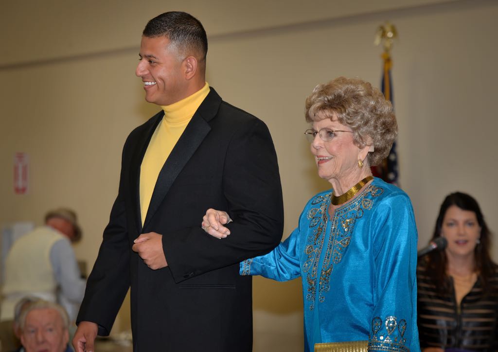 Officer Jorge Sanchez and Rena Spagnola walk the runway arm-in-arm during the Mother’s Day Luncheon & Fashion Show at the Tustin Area Senior Center. Photo by Steven Georges/Behind the Badge OC