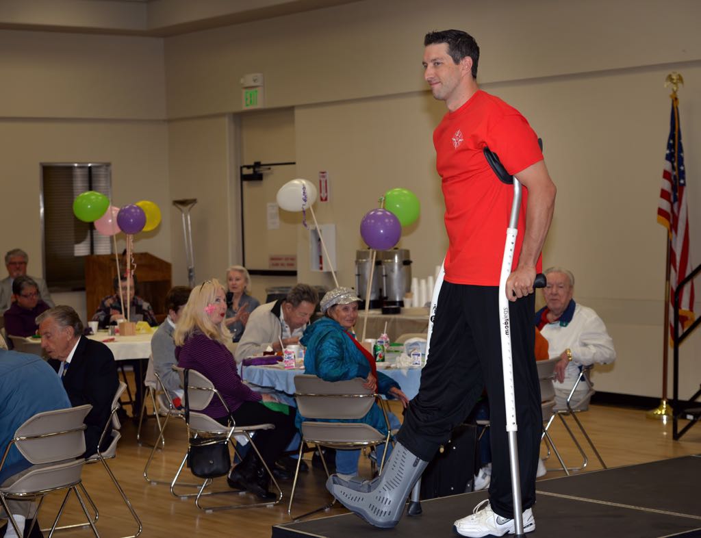 Officer Matt Roque looks sharp as he walks out despite his injury during the Mother’s Day Luncheon & Fashion Show at the Tustin Area Senior Center. Photo by Steven Georges/Behind the Badge OC