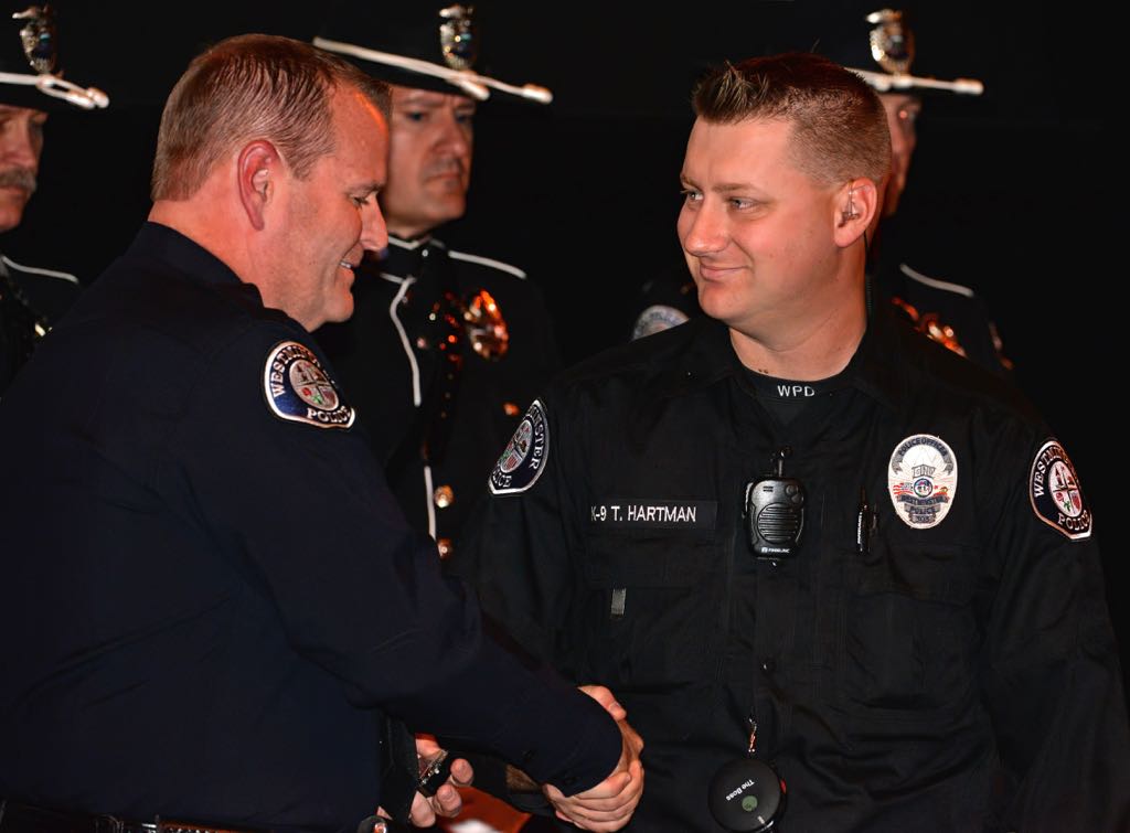 Officer Travis Hartman receives the Life Saving Medal from Chief Kevin Baker during the 2014 Westminster PD Awards Ceremony. Photo by Steven Georges/Behind the Badge OC