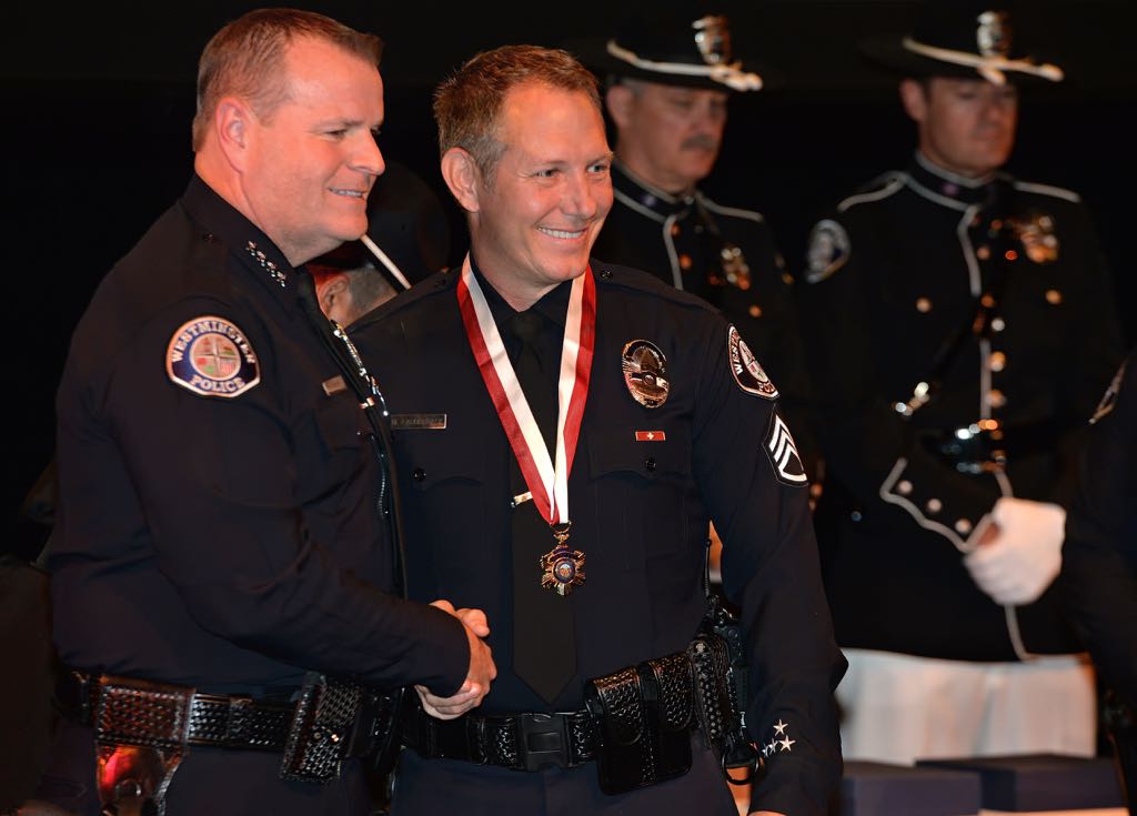 Sgt. Mark Lauderback receives the Medal of Merit from Chief Kevin Baker during the 2014 Westminster PD Awards Ceremony. Photo by Steven Georges/Behind the Badge OC