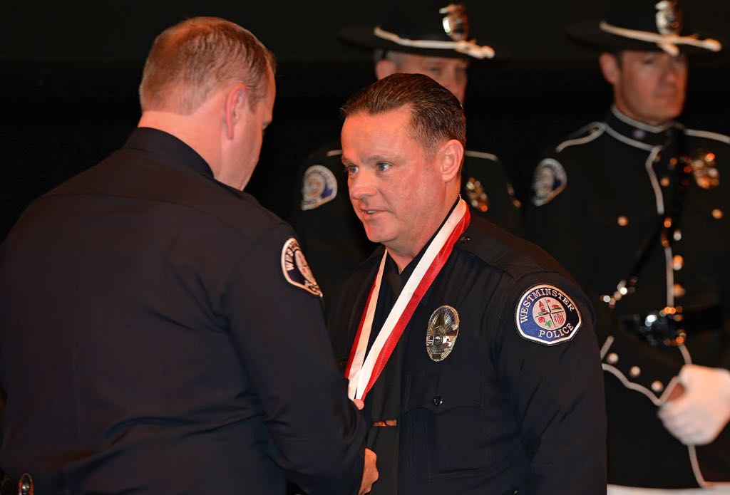 Officer William Eifert receives the Medal of Merit from Chief Kevin Baker during the 2014 Westminster PD Awards Ceremony. Photo by Steven Georges/Behind the Badge OC