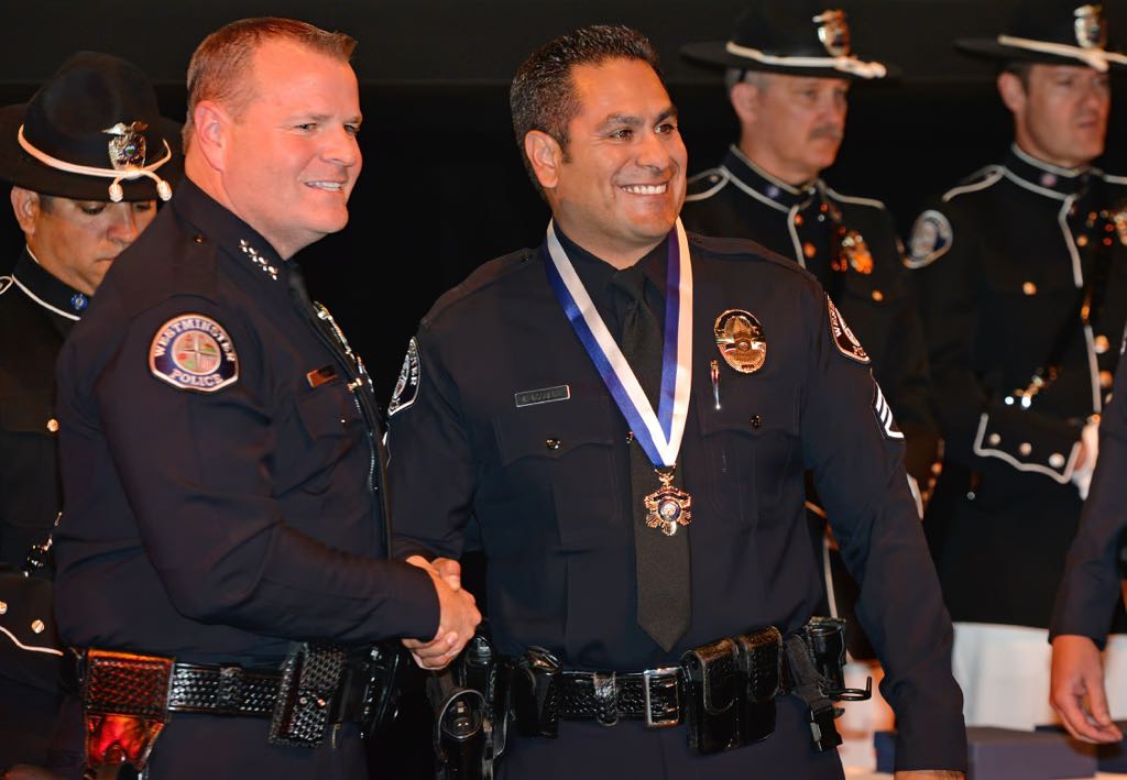 Sgt. Eddie Esqueda receives the Medal of Courage from Chief Kevin Baker during the 2014 Westminster PD Awards Ceremony. Photo by Steven Georges/Behind the Badge OC