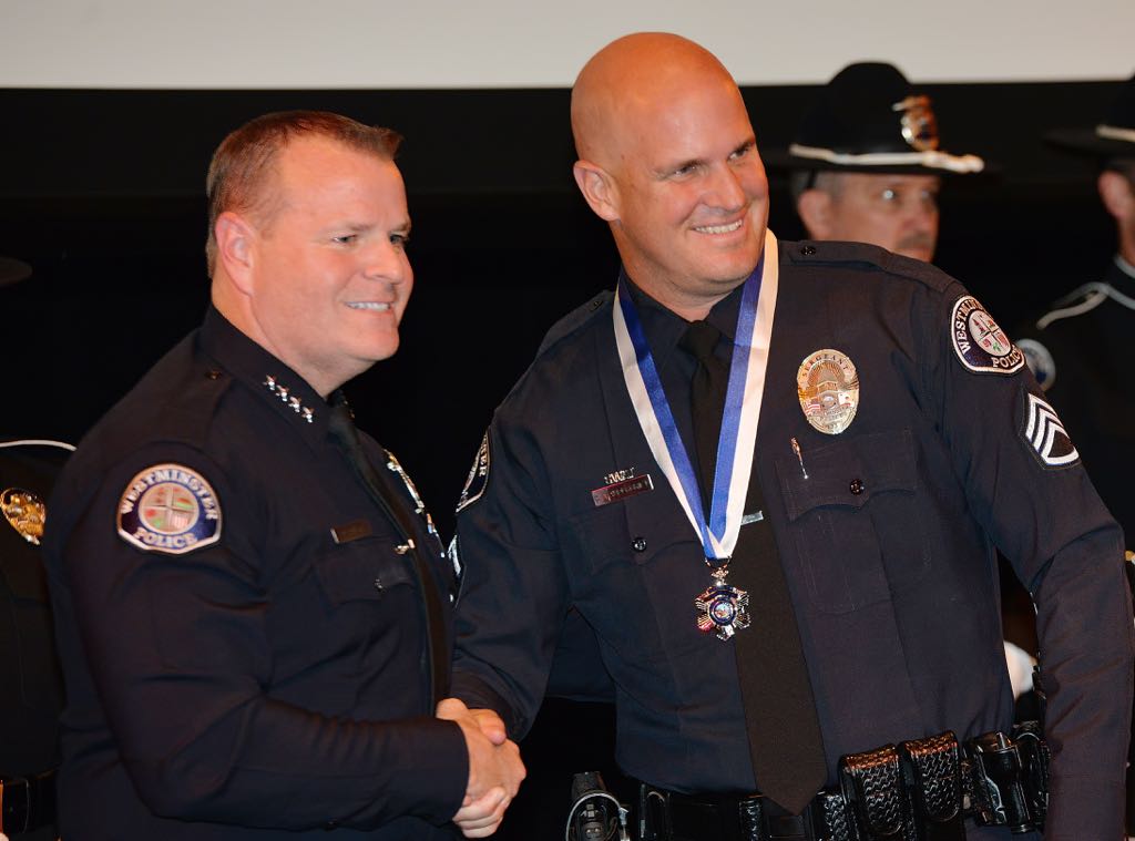Sgt. Cord Vandergrift receives the Medal of Courage from Chief Kevin Baker during the 2014 Westminster PD Awards Ceremony. Photo by Steven Georges/Behind the Badge OC