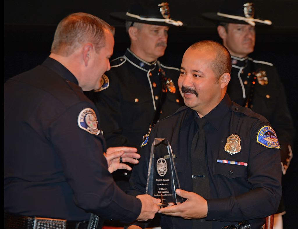Receiving the Chief’s Award from Westminster Police Chief Kevin Baker is Seal Beach Police Officer Joe Garcia during the 2014 Westminster PD Awards Ceremony. Photo by Steven Georges/Behind the Badge OC