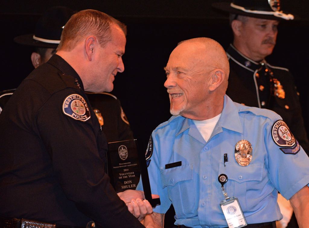 Don Shuler, right, is congratulated by Westminster Police Chief Kevin Baker as the 2014 Volunteer of the Year, one of two, during the 2014 Westminster PD Awards Ceremony. Photo by Steven Georges/Behind the Badge OC