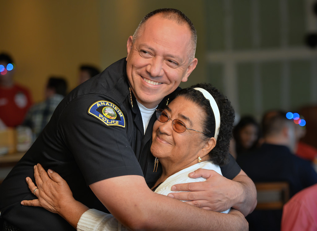 Anaheim Police Chief Raul Quezada gets a big hug from Maria Rivas of Anaheim during the Tip-A-Cop fundraiser. Maria, who’s apartment burned down on Mother’s day a year ago displacing her and her family, received donations and other help from individuals at the PD to get them back on their feet. Photo by Steven Georges/Behind the Badge OC