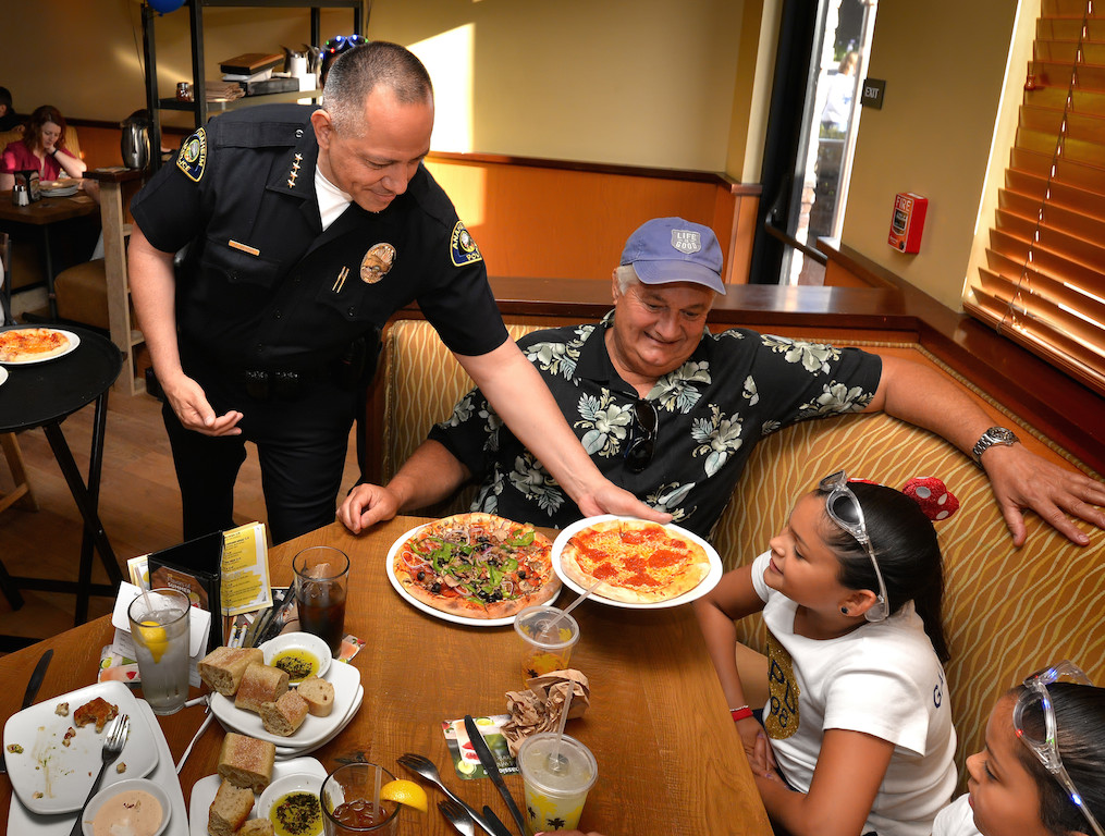 Anaheim Police Chief Raul Quezada delivers pizza to 7-year-old Madison Gallacher of Orange during the Tip-A-Cop Tip-A-Cop fundraiser for Anaheim PD’s Cops for Kids. Photo by Steven Georges/Behind the Badge OC