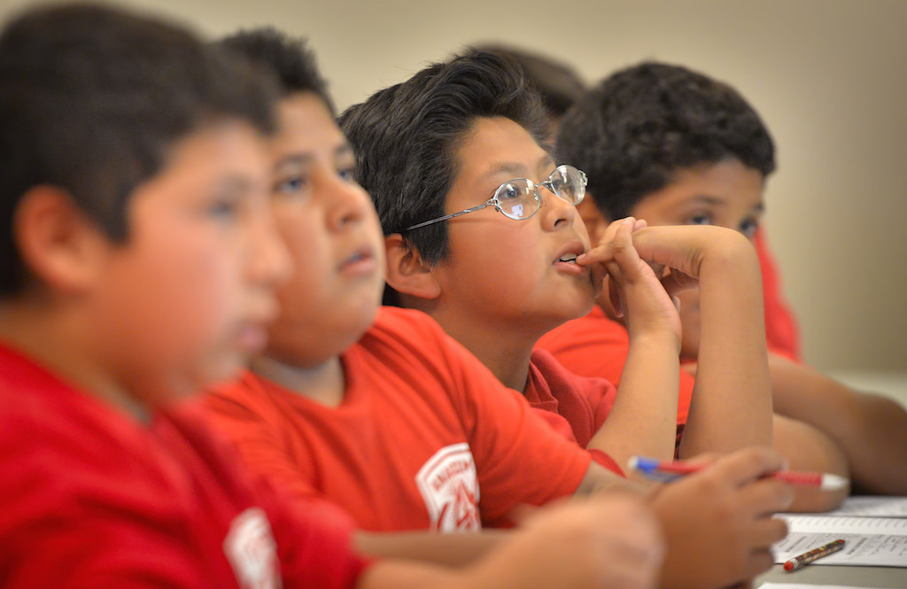 Jr. Cadets listen to a lecture on 911 calls during a Cops for Kids class at Paul Revere Elementary in Anaheim. The red shirts are the advance class. Photo by Steven Georges/Behind the Badge OC