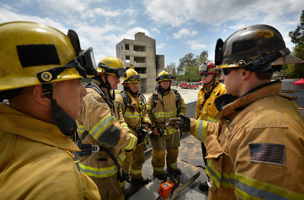 Anaheim Fire & Rescue recruits have their performance rated after a rooftop test at the North Net Training Center in Anaheim. Photo by Steven Georges/Behind the Badge OC