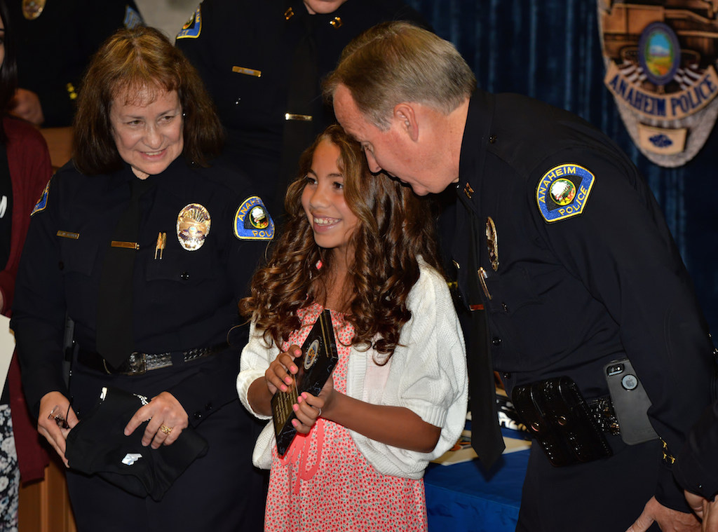 Marisa Maldonado, 6th grade of Salk Elementary, receives an award for Outstanding Achievement and Exemplary Behavior during the Do the Right Thing awards ceremony at the Anaheim police headquarters. Photo by Steven Georges/Behind the Badge OC