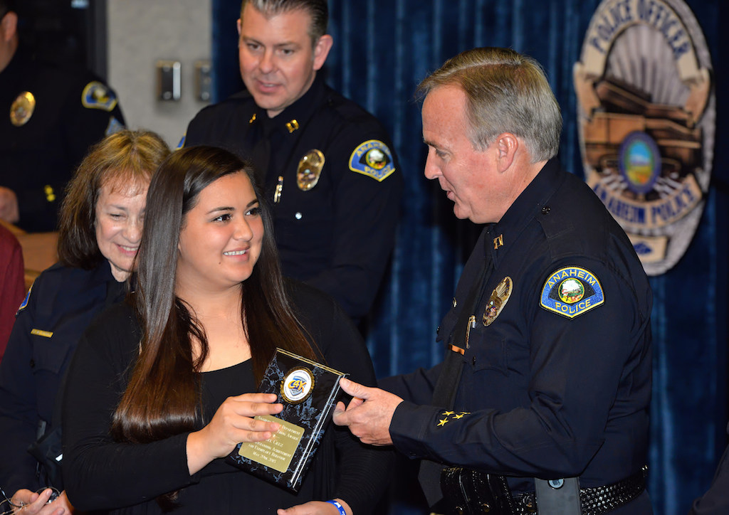 Isabel Cruz, junior at Villa Park High, receives an award for Outstanding Achievement and Exemplary Behavior during the Do the Right Thing awards ceremony at the Anaheim police headquarters. Photo by Steven Georges/Behind the Badge OC