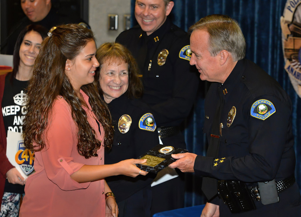 Kristina Marusic, senior at Katella High, receives an award for Outstanding Achievement and Exemplary Behavior from Captain Mark Cyprien during the Do the Right Thing awards ceremony at the Anaheim police headquarters. Photo by Steven Georges/Behind the Badge OC
