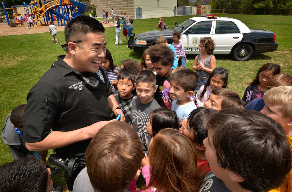 Officer Michael Yang gets the kids excited as he brings out his handcuffs during the Team Kids Challenge Carnival at Rolling Hills Elementary benefiting cystic fibrosis research and education. Photo by Steven Georges/Behind the Badge OC