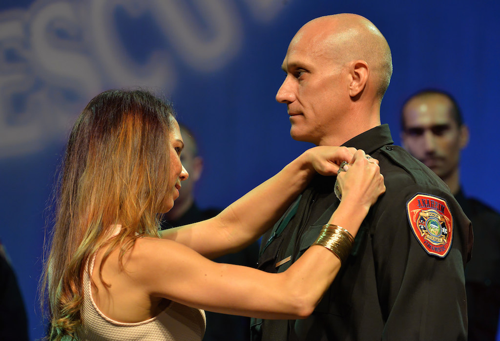Anaheim Firefighter Jade Morgan receives his badge during the Anaheim Fire & Rescue Promotion and Graduation ceremony. Photo by Steven Georges/Behind the Badge OC