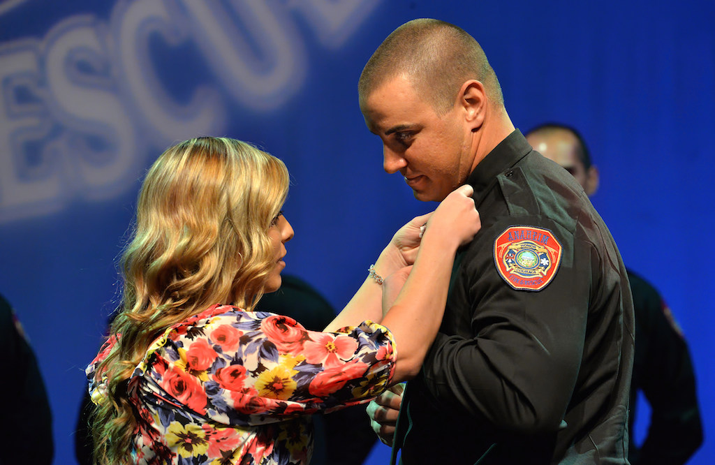 Michael Hoover receives his badge from his wife Dominique. Photo by Steven Georges/Behind the Badge OC