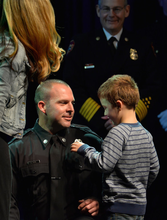 Captain Kevin Kane receives his new badge from his wife, Francesca Kane and their son during the Anaheim Fire & Rescue Promotion and Graduation ceremony. Photo by Steven Georges/Behind the Badge OC