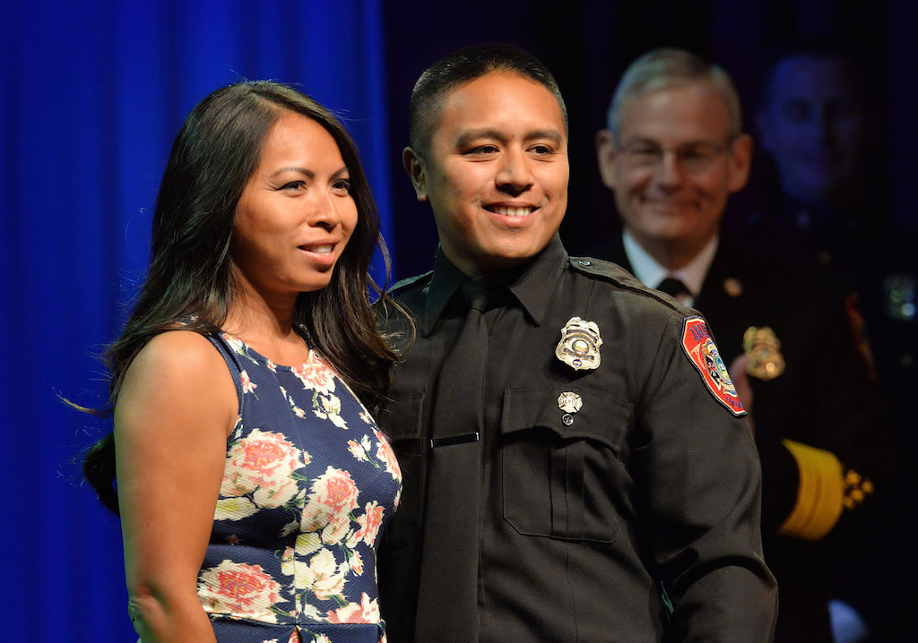 Fire Engineer Jeff Nimsiriruengphol with his wife Sophani after receiving his new badge during the Anaheim Fire & Rescue Promotion and Graduation ceremony. Photo by Steven Georges/Behind the Badge OC