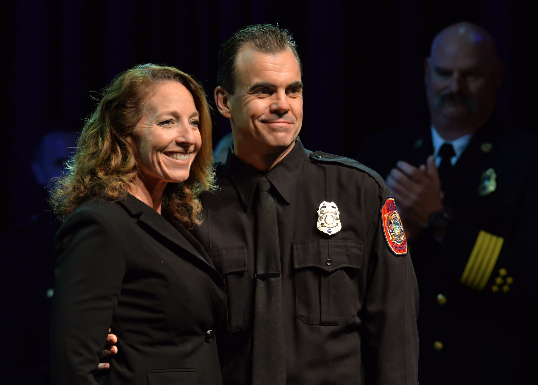 Fire Engineer Shane Kohls with his wife Annette Kohls during the Anaheim Fire & Rescue Promotion and Graduation ceremony. Photo by Steven Georges/Behind the Badge OC