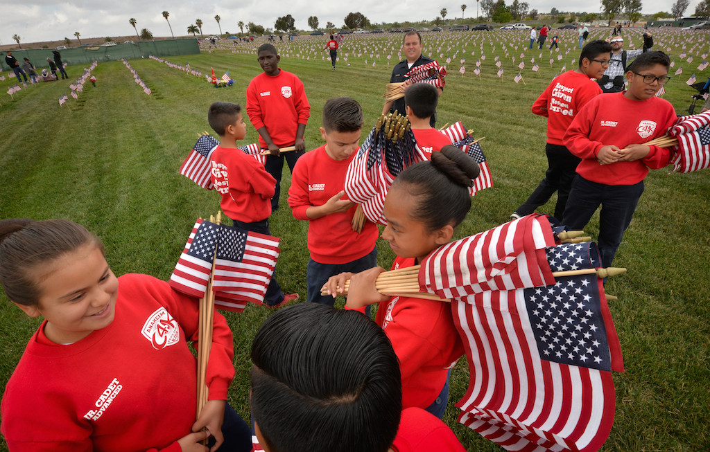 Anaheim PD Jr. Cadets gather to place American flags at Riverside National Cemetery (next to March Air Reserve Base) for Memorial Day weekend, part of A Flag for Every Hero. Photo by Steven Georges/Behind the Badge OC