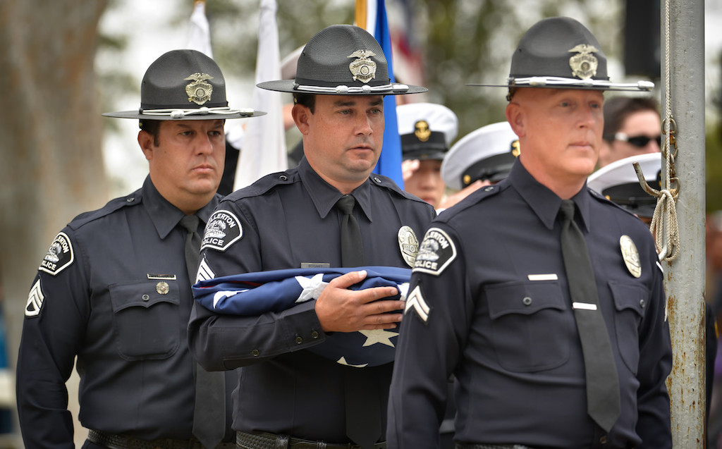 Sgt. Dan Castillo, left, Sgt. Tony Bogart and Cpl. Scott Moore of the Fullerton Police Officer Color Guard carry the flag during the Presentation of Colors for the 77th Annual Memorial Day Ceremony at Loma Vista Memorial Park in Fullerton. Photo by Steven Georges/Behind the Badge OC