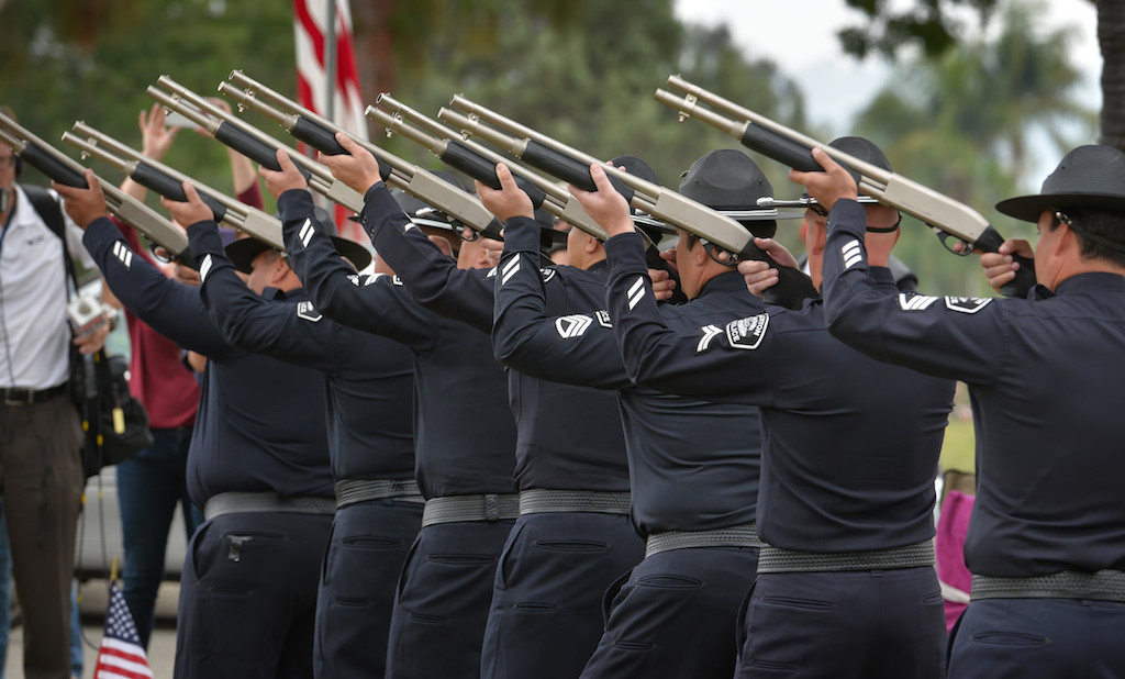 Firing off a Twenty One Gun Salute for the 77th Annual Memorial Day Ceremony are the Fullerton Police Honor Guard members Officer Richie Herrera, left, Officer Miguel “Sonny” Siliceo, Cpl. Mike Moon, Cpl. Billy Phu, Sgt. Dan Castillo, Cpl. Scott Moore and Sgt. Tony Bogart. Photo by Steven Georges/Behind the Badge OC