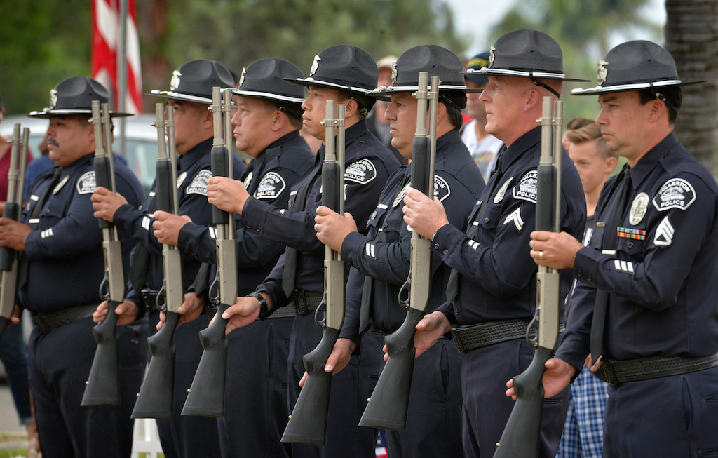 In formation for the Twenty One Gun Salute during the 77th Annual Memorial Day Ceremony are the Fullerton Police Honor Guard members Officer Richie Herrera, left, Officer Miguel “Sonny” Siliceo, Cpl. Mike Moon, Cpl. Billy Phu, Sgt. Dan Castillo, Cpl. Scott Moore and Sgt. Tony Bogart. Photo by Steven Georges/Behind the Badge OC