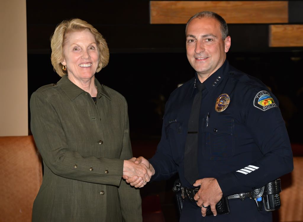 Volunteer Andie Ervin receives a pin from Tustin Police Chief Charles Celano for 2500 hours of work during Tustin PD’s annual volunteer appreciation awards dinner. Photo by Steven Georges/Behind the Badge OC