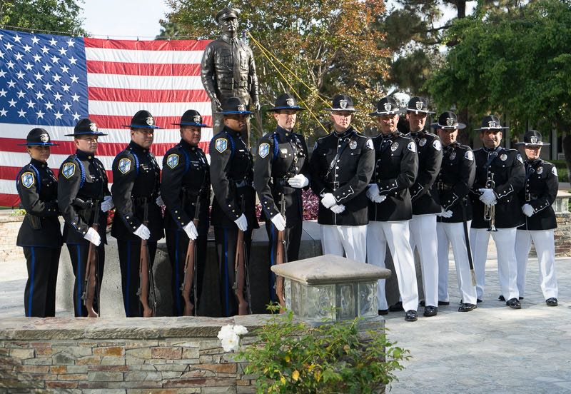 Members of the Irvine and Westminster police departments stand at attention in front of the Westminster Police Department Memorial. Photo by Jim Banks/Behind the Badge OC 