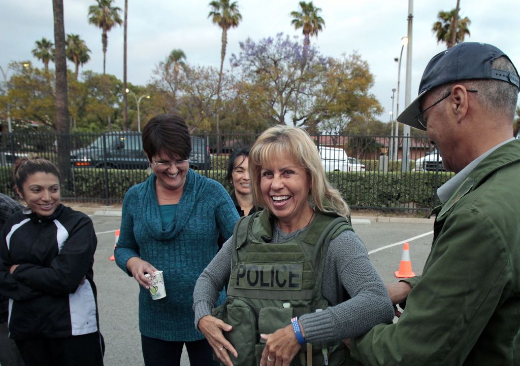 Carrie Surich gets a laugh while wearing a ballistic armor vest during a demonstration by members of SWAT during the La Habra Citizens' Police Academy.   Photo by Christine Cotter/Behind the Badge OC