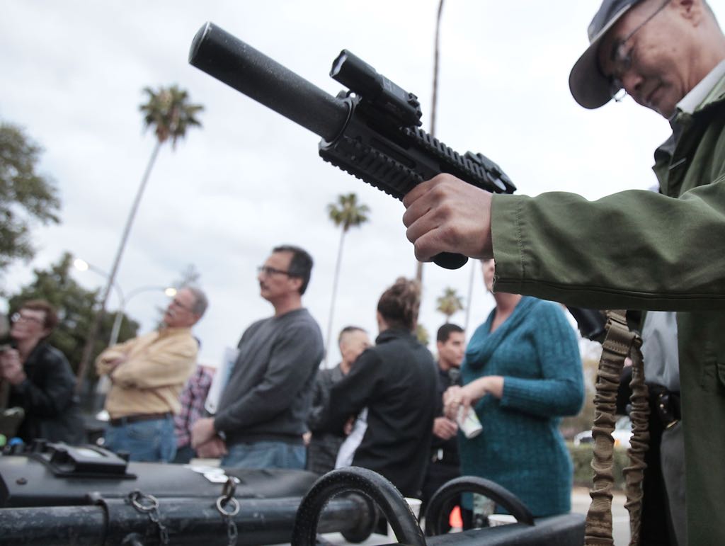 Resident John Shea gets a close-up look  at an assault rifle used by members of the SWAT team during a demonstration at the La Habra Police Department's Citizens' Police Academy.   Photo by Christine Cotter/Behind the Badge OC