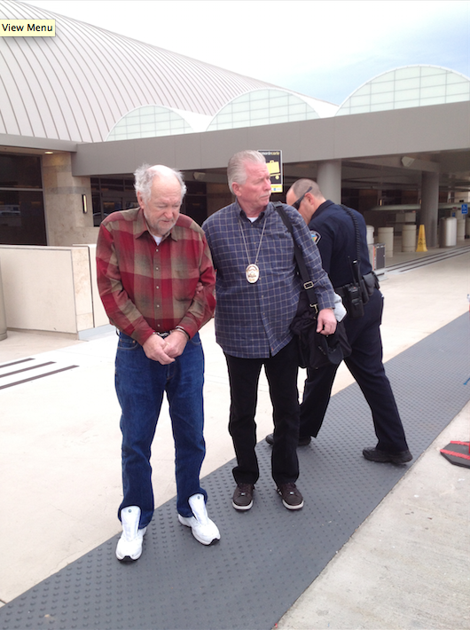 Tustin Reserve Det. Bruce Williams escorts Charles Lee Clark from Oregon. Clark was arrested in 2013 for the 1990 murder of Kathleen Witkowski. Photo courtesy Tustin PD. 