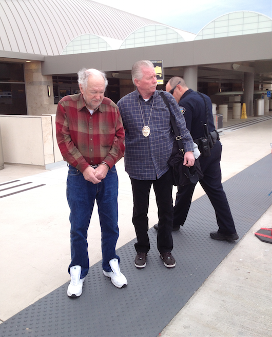 Tustin Reserve Det. Bruce Williams escorts Charles Lee Clark from Oregon. Clark was arrested in 2013 for the 1990 murder of Kathleen Witkowski. Photo courtesy Tustin PD. 