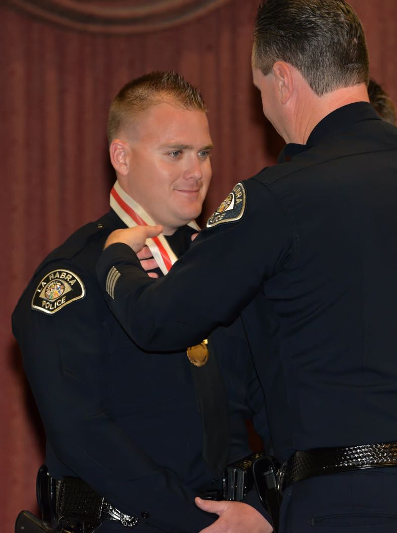Officer Travis Nelson receives the Lifesaving Medal from La Habra Police Chief Jerry Price during the La Habra Police Department Awards & Commendations Ceremony. Photo by Steven Georges/Behind the Badge OC
