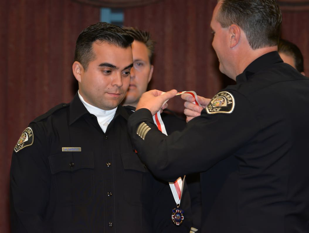 Officer Mucio Sanchez receives the Lifesaving Medal from La Habra Police Chief Jerry Price during the La Habra Police Department Awards & Commendations Ceremony. Photo by Steven Georges/Behind the Badge OC