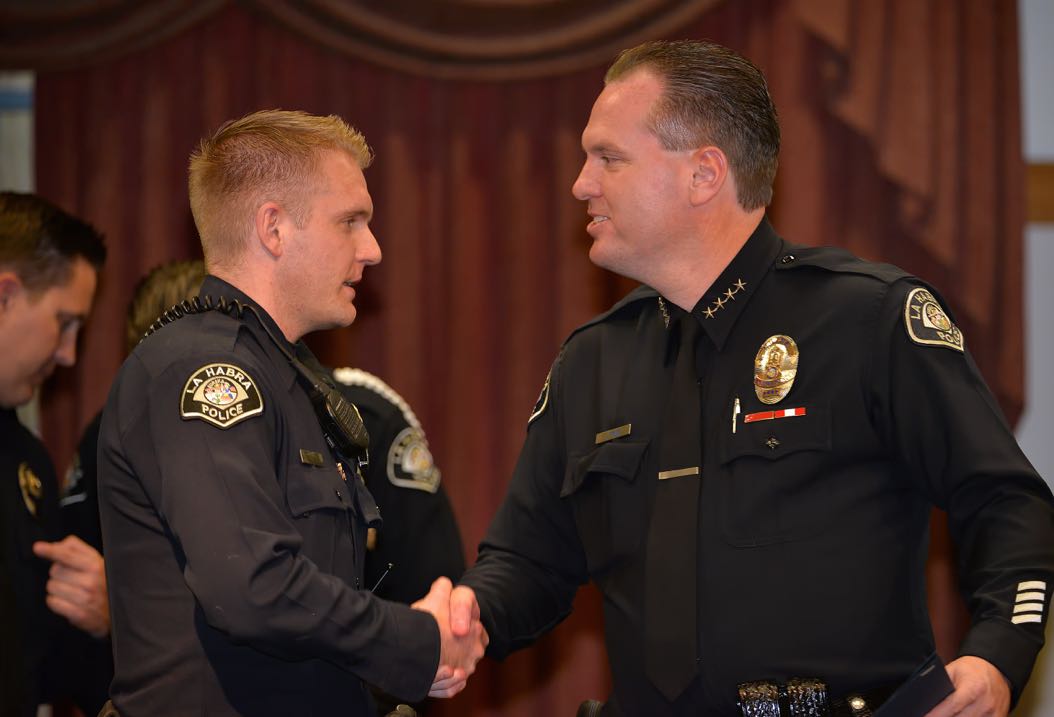 Officer Nick Wilson receives the Chief’s Citation from La Habra Police Chief Jerry Price during the La Habra Police Department Awards & Commendations Ceremony. Photo by Steven Georges/Behind the Badge OC