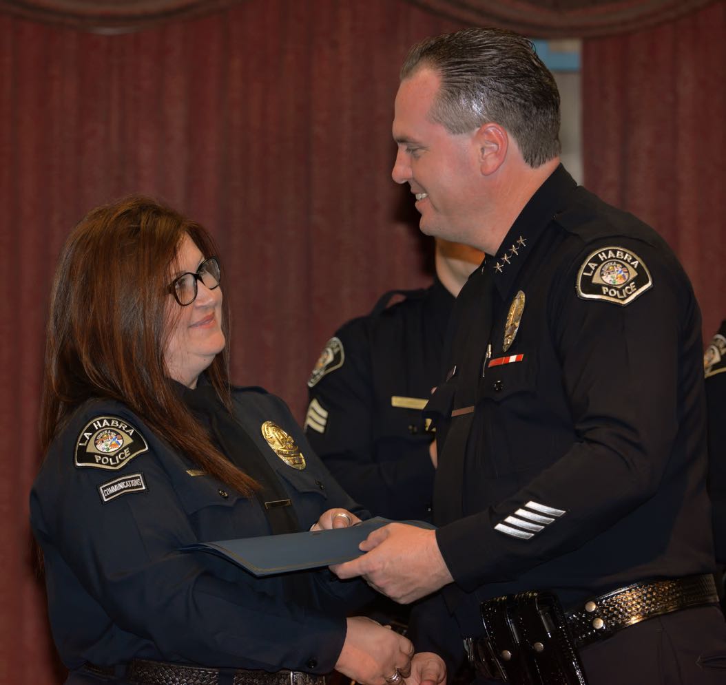 Communications Operator Cathy Gonzalez receives the Chief’s Citation from La Habra Police Chief Jerry Price during the La Habra Police Department Awards & Commendations Ceremony. Photo by Steven Georges/Behind the Badge OC