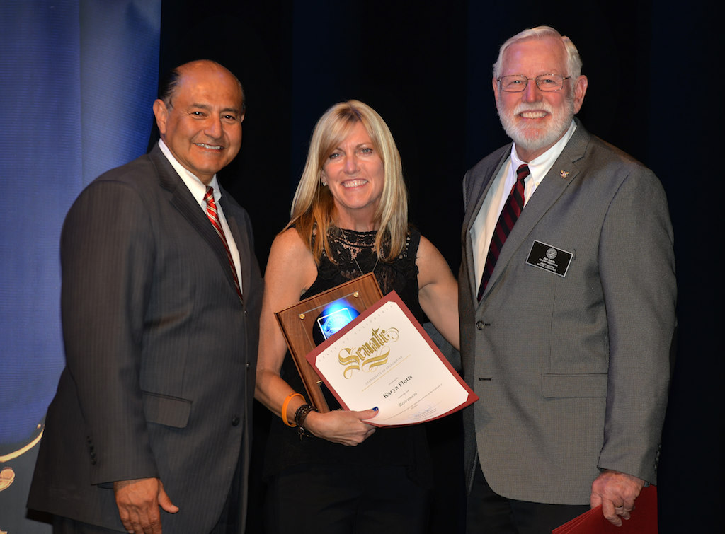 Senior Secretary Karyn Flutts, center, receives recognition of 11 years of service during Anaheim PD’s 2015 Awards and Retirement Ceremony. Photo by Steven Georges/Behind the Badge OC