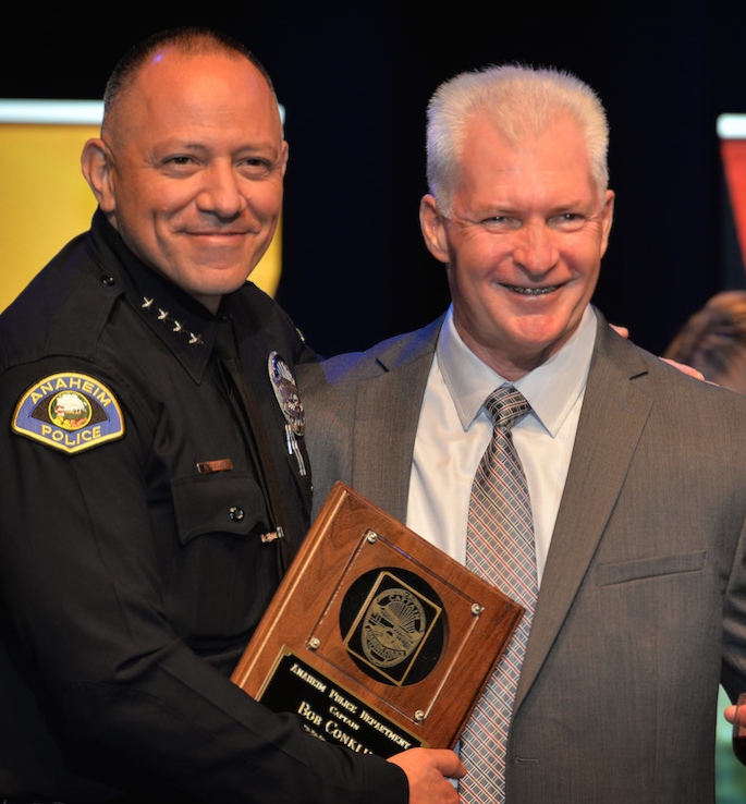 Captain Robert Conklin, right, receives recognition of 34 years of service during Anaheim PD’s 2015 Awards and Retirement Ceremony. Photo by Steven Georges/Behind the Badge OC
