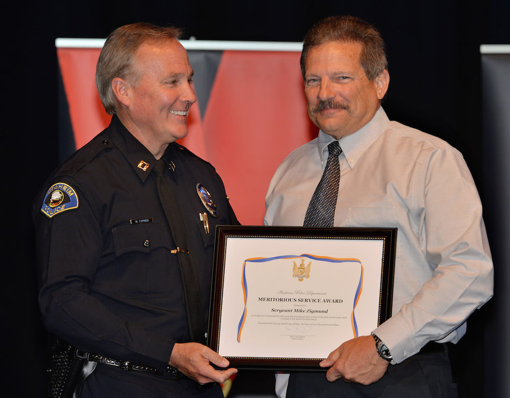 Sgt. Mike Sigmund, right, receives the Meritorious Service award from Lt. Mark Cyprien during Anaheim PD’s 2015 Awards and Retirement Ceremony. Photo by Steven Georges/Behind the Badge OC