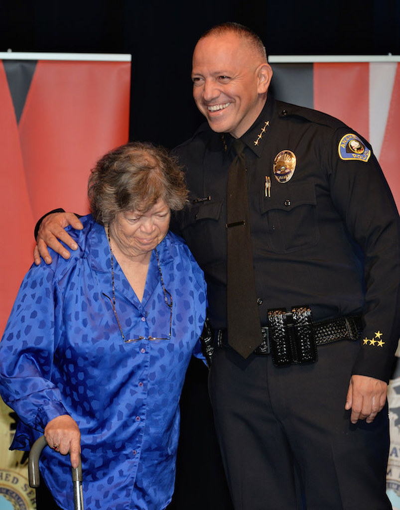 Jennie Negrete walks out on stage with Anaheim Police Chief Raul Quezada as she receives the Chief’s Division Employee of the Year award during Anaheim PD’s 2015 Awards and Retirement Ceremony. Photo by Steven Georges/Behind the Badge OC