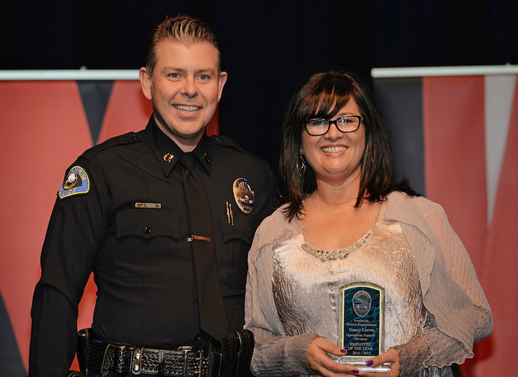 Nancy Loewe, right, receives the Operations Support Division Employee of the Year award from Lt. Jaret Young during Anaheim PD’s 2015 Awards and Retirement Ceremony. Photo by Steven Georges/Behind the Badge OC