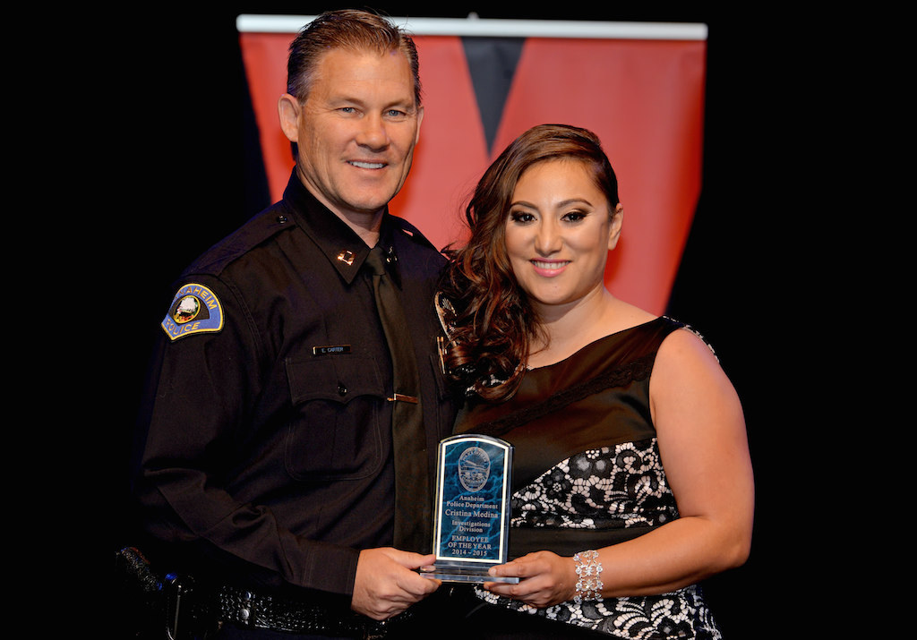 Christina Medina, right, receives the Investigations Division Employee of the Year award from Lt. Eric Carter during Anaheim PD’s 2015 Awards and Retirement Ceremony. Photo by Steven Georges/Behind the Badge OC