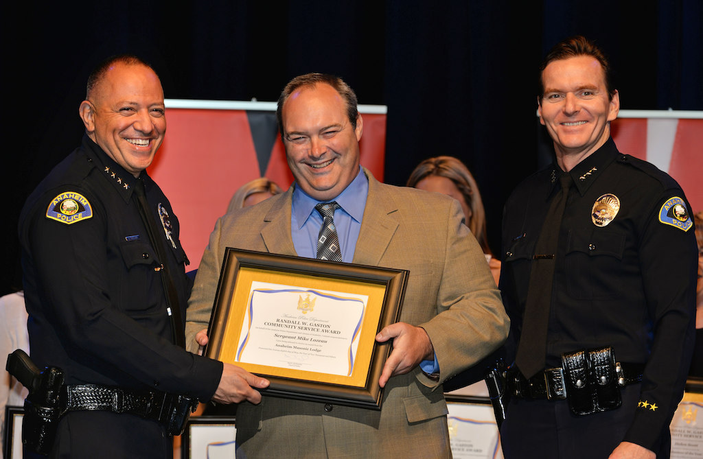 Sgt. Mike Lozeau receives the Anaheim Masonic Lodge Community Service award from Anaheim Police Chief Raul Quezada, left, and Anaheim Deputy Chief Julian Harvey during Anaheim PD’s 2015 Awards and Retirement Ceremony. Photo by Steven Georges/Behind the Badge OC