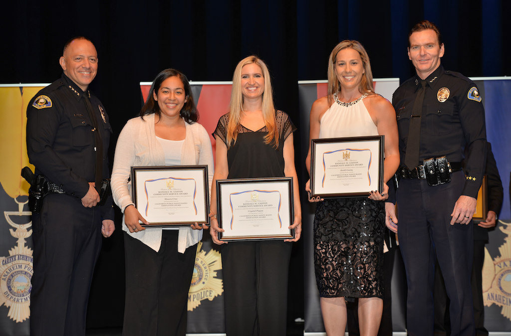 Maura Cruz, center left, Crystal Paqua and Heidi Geary receive the California Public Safety Radio Association Award from Anaheim Police Chief Raul Quezada, left, and Anaheim Deputy Chief Julian Harvey during Anaheim PD’s 2015 Awards and Retirement Ceremony. Not present are Heather Madrick, Michelle Siemer and Rachel Fitzgerald. Photo by Steven Georges/Behind the Badge OC