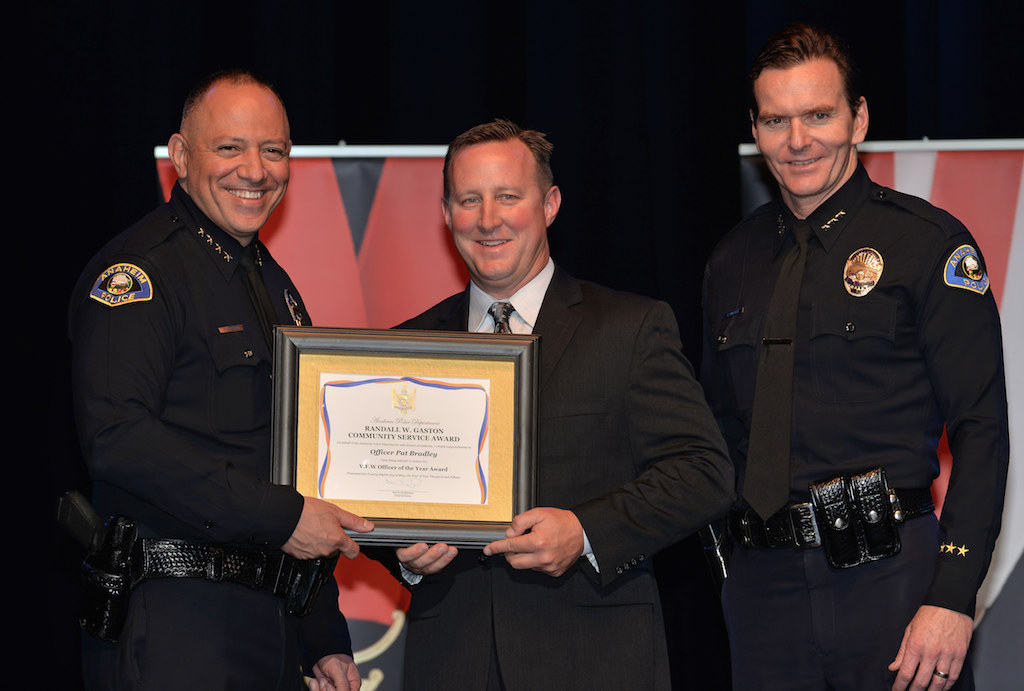 Patrick Bradley receives the V.F.W. Officer of the Year award from Anaheim Police Chief Raul Quezada, left, and Anaheim Deputy Chief Julian Harvey during Anaheim PD’s 2015 Awards and Retirement Ceremony. Photo by Steven Georges/Behind the Badge OC